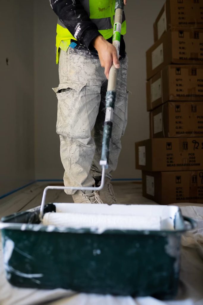 Painter rolling a fresh coat of paint onto an interior wall